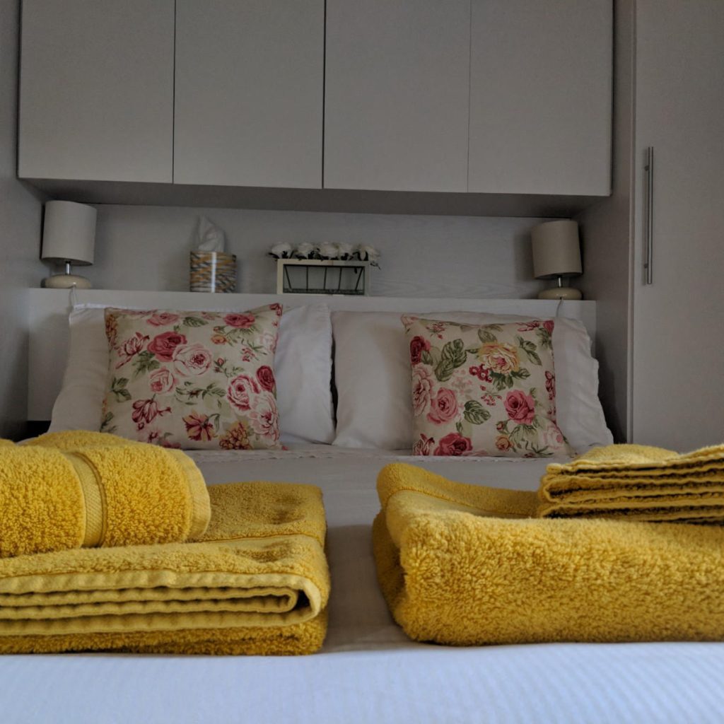 The double bedroom at Beech Lynette, with yellow throws on the bed