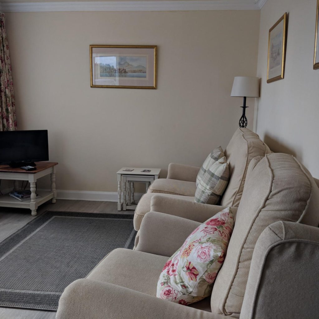 The lounge at Beech Lynette, with a sofa and armchair